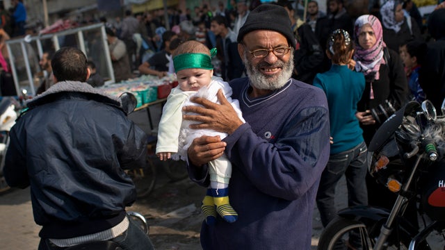 A Palestinian baby wears a Hamas bandana at a rally to celebrate the Israel-Hamas cease-fire 