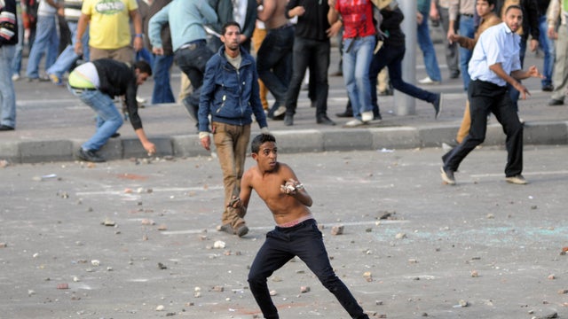 Egyptian supporters and opponents of President Mohamed Morsi clash in the Mediterranean coastal city of Alexandria on November 23, 2012. Opponents set fire to Muslim Brotherhood offices in three Egyptian cities, state television reported, as rival rallies 