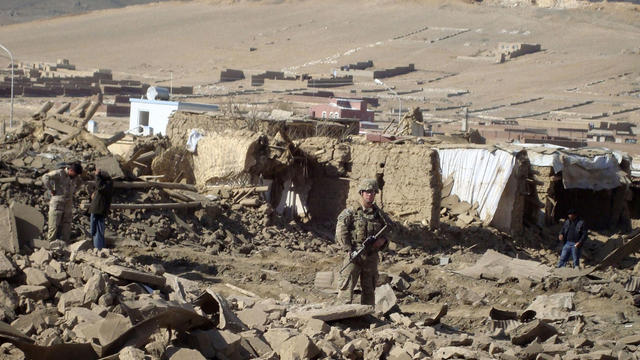  U.S. soldier stands guard at the site of suicide attack in Wardak Province of Kabul Afghanistan, Friday, Nov, 23, 2012.  