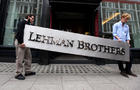 Christie's employees in London haul off Lehman Brothers corporate logo on September 29, 2010, two years after the collapse of the U.S.-based investment bank. 
