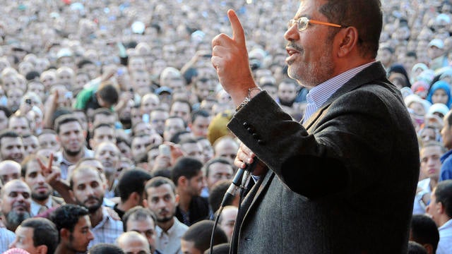 President Mohammed Morsi speaks to supporters outside the Presidential palace in Cairo 