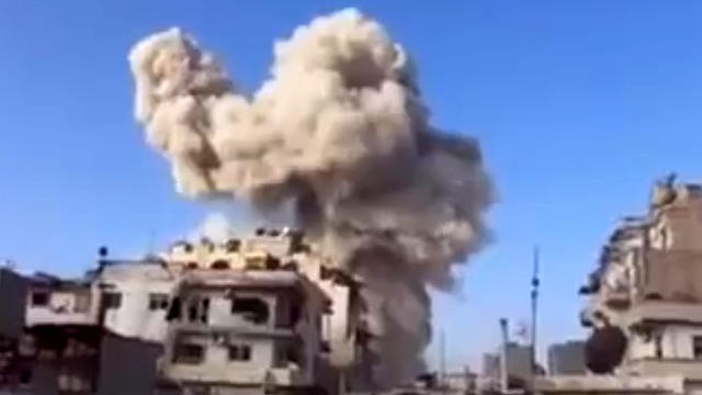 In this image taken from video obtained from the Ugarit News, which has been authenticated based on its contents and other AP reporting, smoke leaps the air from a building after a warplane attack in Homs, Syria, on Wednesday, Nov. 28, 2012.  