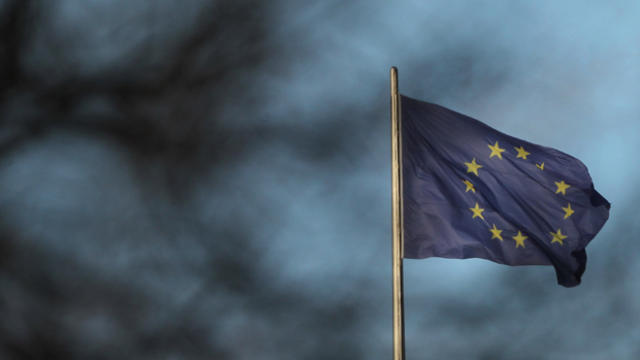 The European Union flag appears through tree branches on Nov. 30, 2011, in Berlin. 