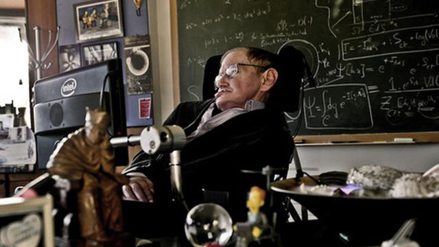 A photograph of Stephen Hawking in his office, surrounded by some of the memorabilia now on display at the Science Museum. 