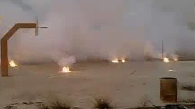 Allged incendiary bomb submunitions burn on the ground in Syria 