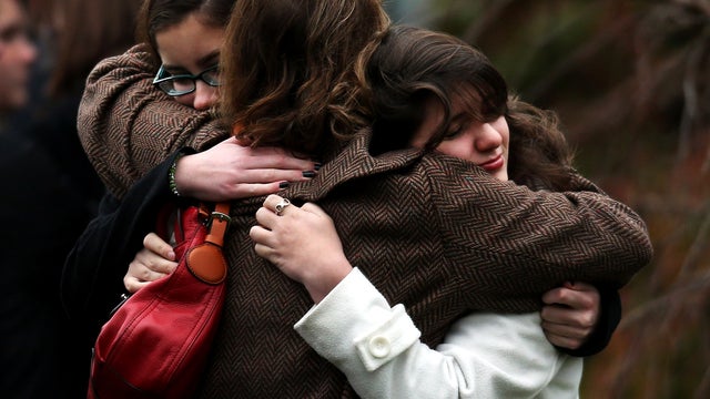 Three women embrace as they arrive for the funeral services of 6-year-old Noah Pozner, who was killed in the shooting massacre in Newtown, Conn., at Abraham L. Green and Son Funeral Home Dec. 17, 2012, in Fairfield, Conn. 