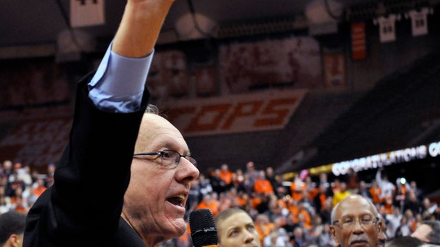 Syracuse coach Jim Boeheim acknowledges the crowd as Detroit Mayor Dave Bing, right, watches after Syracuse defeated Detroit 72-68 for Boeheim's 900th career victory in an NCAA college basketball game in Syracuse, N.Y., Monday, Dec. 17, 2012. Bing and Boe 