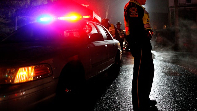 A Connecticut state trooper mans a checkpoint on the road leading toward Sandy Hook Elementary Dec. 17, 2012, in Newtown, Conn. 