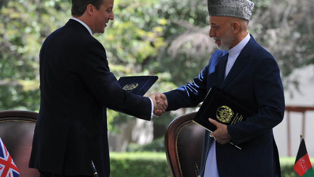 Britain's Prime Minister David Cameron and Afghan President Hamid Karzai shake hands 