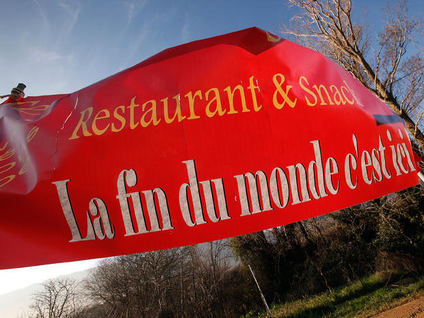 A sign, which says "The end of the world is here," advertises a restaurant in Bugarach, France, Dec. 20, 2012. 