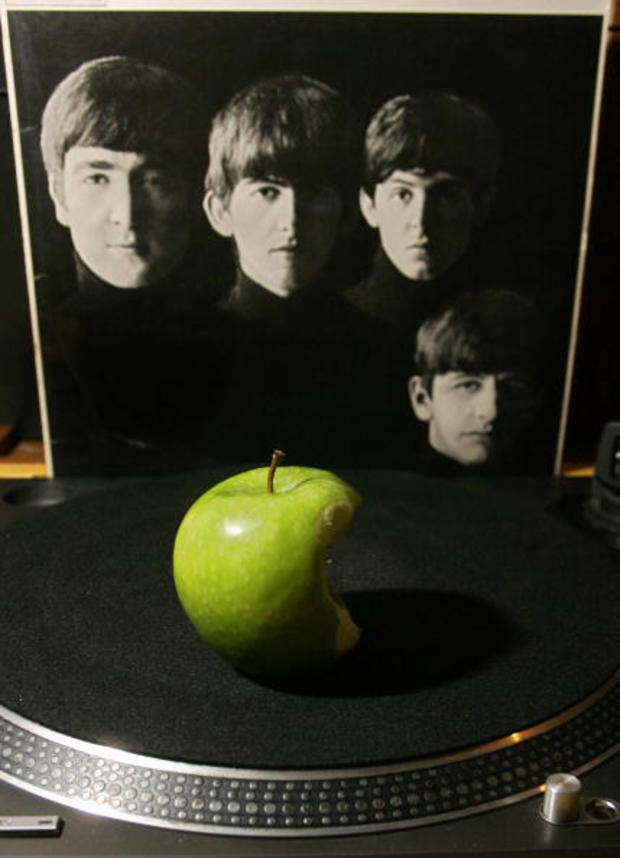 An apple is placed on a turntable agains 