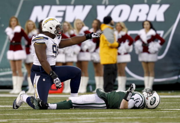 Kendall Reyes #91 of the San Diego Chargers &amp; Greg McElroy #14 of the New York Jets 