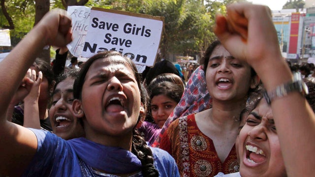 Indian students shout slogans during a rally against violence toward women 