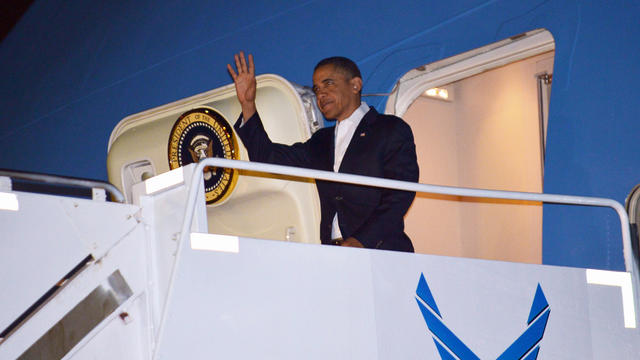 President Obama steps off Air Force One upon arrival at Hickam Air Force Base near Honolulu 