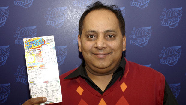 This undated photo provided by the Illinois Lottery shows Urooj Khan, 46, of Chicago's West Rogers Park neighborhood, posing with a winning lottery ticket. 