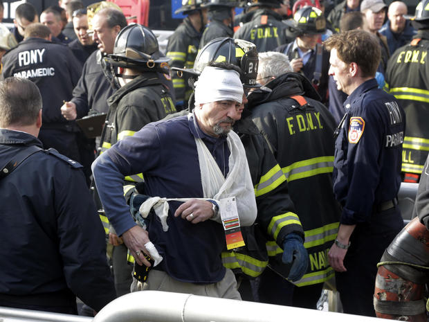 An injured passenger of the Seastreak Wall Street ferry is aided by New York City firefighters in New York Jan. 9, 2013. 