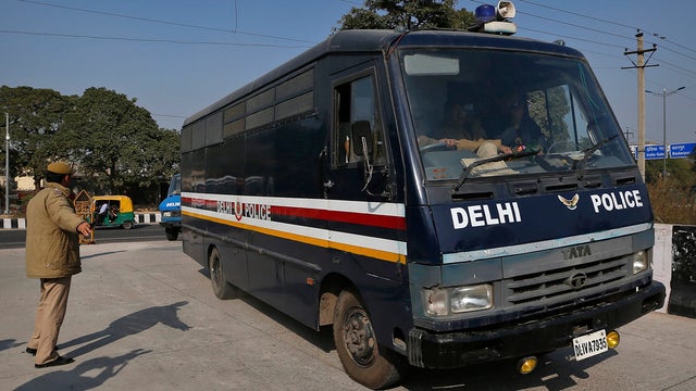 A van believed to be carrying the accused in a gang-rape, enters a district court in New Delhi 