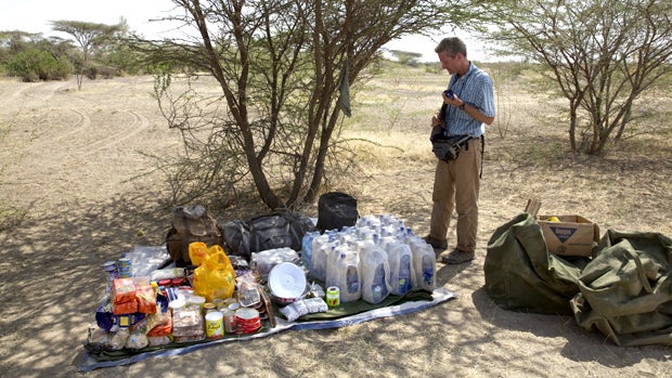 This photo taken Wednesday, Jan. 9, 2013 and released by the National Geographic Society on Thursday, Jan. 10, 2013, shows Paul Salopek standing by the supplies he will be taking in the village of Herto Bouri, Ethiopia. 