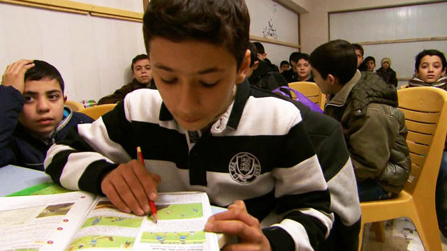 Omar, 13, attends a makeshift school in Turkey with 500 other children who have fled Syria's civil war. 