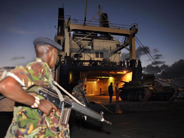 Kenyan military officer keeps guard as Soviet made T-72 tanks are offloaded from the MV Faina ship at the port of Mombasa 