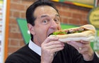 Subway co-founder and chairman Fred DeLuca in 2011 poses with a sandwich 