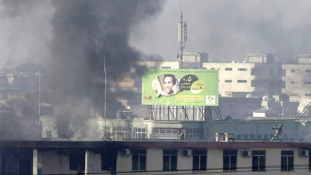 Afghan security officers on the roof of the Kabul traffic police headquarters 