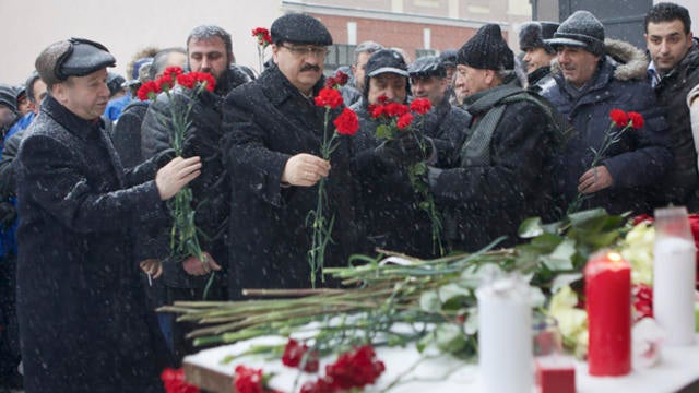 Syrian Ambassador to Russia Riyad Haddad, second left, lays flowers during a memorial action at the Syrian Embassy in Moscow, Thursday, Jan. 17, 2013. Pro-government Syrians and their Russian supporters gathered at the Syrian Embassy in memory of dozens o 