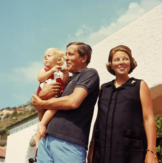 In this July 25, 1968 file photo, Netherlands' Queen Beatrix, and her husband Prince Claus pose with their 15-month-old son Prince Willem Alexander in front of the Royal family's summer villa in Porto Ercole, Italy.  