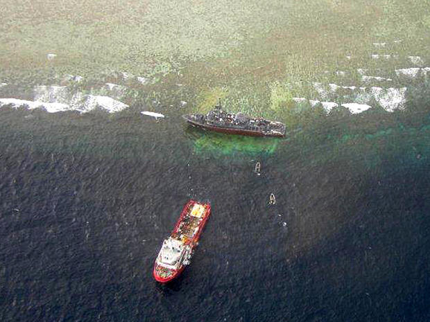 The U.S. Navy minesweeper USS Guardian, top, is seen stranded on the Tubbataha Reef, a World Heritage Site in the Sulu Sea 400 miles southwest of Manila, Philippines, Jan. 25, 2013,  in this picture released by the Tubbataha Management Office. 