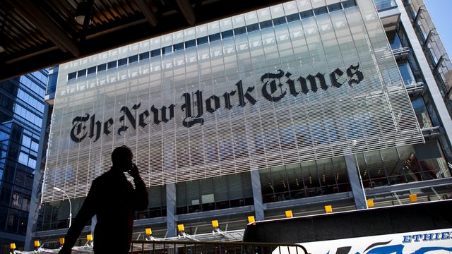 A man speaks on his mobile phone across from The New York Times headquarters building April 21, 2011, in New York City. 