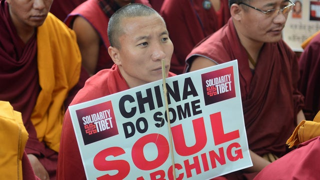 Tibetan Buddhist monks, nuns and activists attend a protest rally 