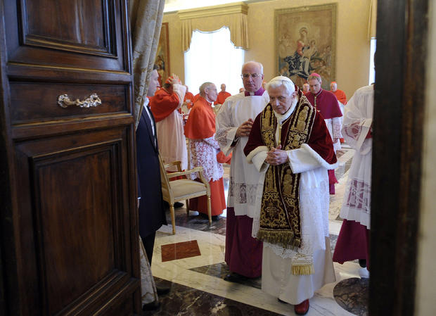 Pope Benedict XVI leaves a meeting after announcing his pending resignation at the Vatican 