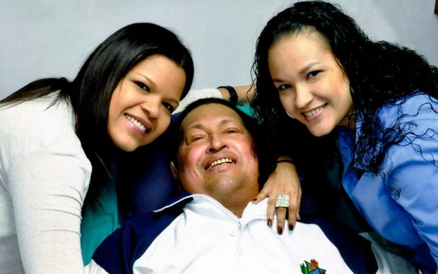 Hugo Chavez poses for a photo with his daughters, Maria Gabriela, left, and Rosa Virginia 
