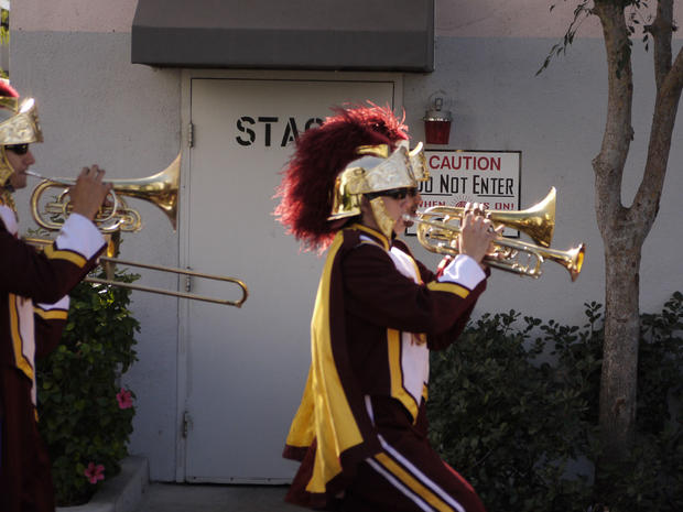 Members of the USC Trojan Marching Band parade through the set.   