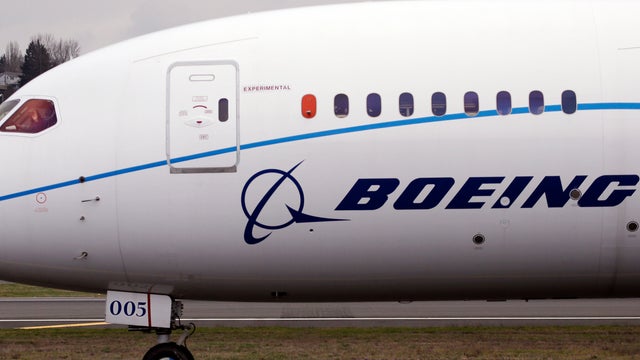 A pilot waves to bystanders while taxiing after landing a Boeing 787 flight test jet following a test flight Feb. 11, 2013, at Boeing Field in Seattle. 