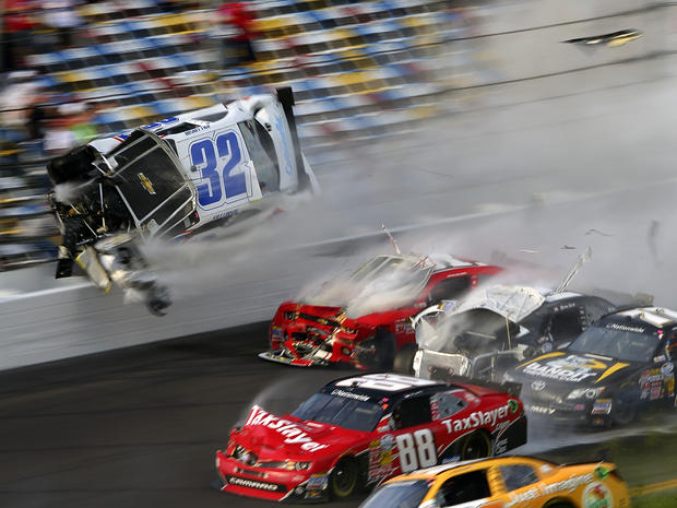 Kyle Larson (32) goes airborne before catching the fencing in a wreck including Dale Earnhardt Jr. (88), Parker Kligerman (77), Justin Allgaier (31) and Brian Scott (2) during the final lap of the NASCAR Nationwide Series auto race at Daytona Internationa 