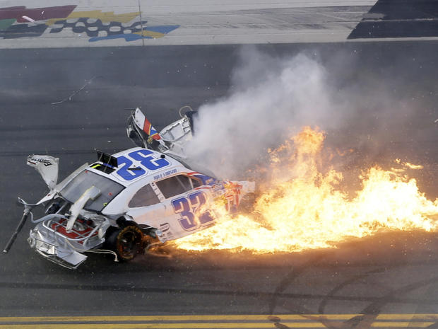 Kyle Larson's car leaves a trail of flames following a crash at the conclusion of the NASCAR Nationwide Series auto race Feb. 23, 2013, at Daytona International Speedway in Daytona Beach, Fla. 