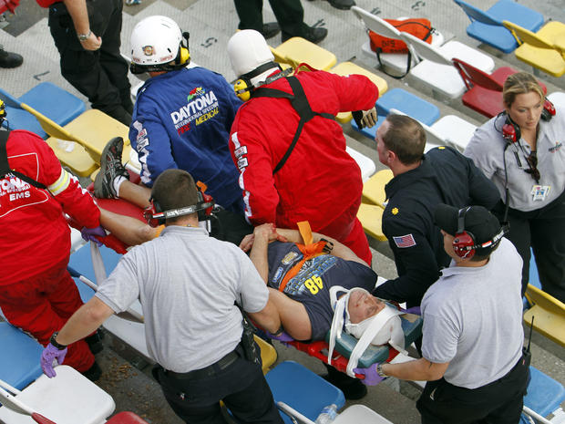 An injured spectator is carried away after a crash at the conclusion of the NASCAR Nationwide Series auto race Feb. 23, 2013, at Daytona International Speedway in Daytona Beach, Fla. 