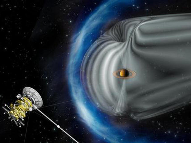 This artist's impression shows NASA's Cassini spacecraft exploring the magnetic environment of Saturn. Saturn's magnetosphere is depicted in grey, while the complex bow shock region ÃƒÂ¢?? the shock wave in the solar wind that surrounds the magnetosphere ÃƒÂ¢?? is shown in blue. The image is not to scale. 