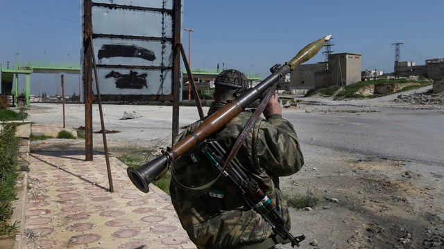 A Free Syrian Army fighter holds his RPG at the Aleppo-Damascus highway which is controlled by the rebels to cut supply for the Syrian army forces. 