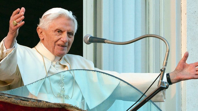 Pope Benedict XVI waves to faithful from a balcony upon arrival in Castel Gandolfo 