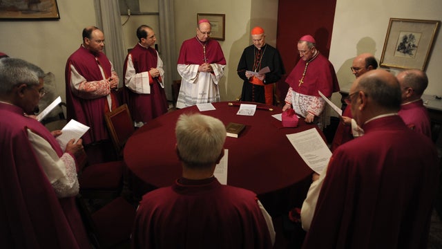 Cardinal Tarcisio Bertone, Vatican Secretary of State, at center with red skull cap, officially takes over the vacant See as camerlengo, chamberlain, before sealing Pope Benedict XVI's apartment 