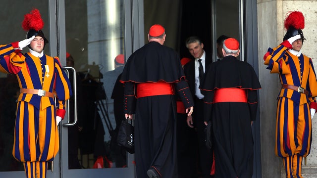  The Archbishop of New York, cardinal Timothy Dolan (2nd L) and the former Archbishop of Philadelphia, Cardinal Justin Rigali (2nd R), arrive at the Paul VI hall for the opening of the Cardinals' Congregations on March 4, 2013 in Vatican City, Vatican. 