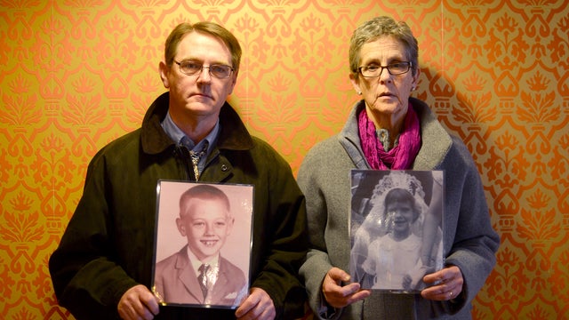 Members of the US-based international support group, the Survivors Network of those Abused by Priests (SNAP), victims outreach director Barbara Dorris (R) and executive director David Clohessy pose with pictures of them as children prior a press conferenc 