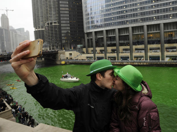 John Shepard and Gena Damento of Rochester, Minn., take a photo of themselves kissing after the Chicago River was dyed green ahead of the St. Patrick's Day parade in Chicago March 16, 2013. With the holiday itself falling on a Sunday, many celebrations we 