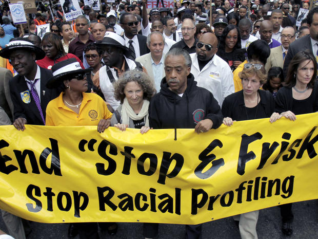 In this June 17, 2012 file photo, Rev. Al Sharpton, center, walks with thousands along Fifth Avenue, during a silent march to end the "stop-and-frisk" program in New York. 