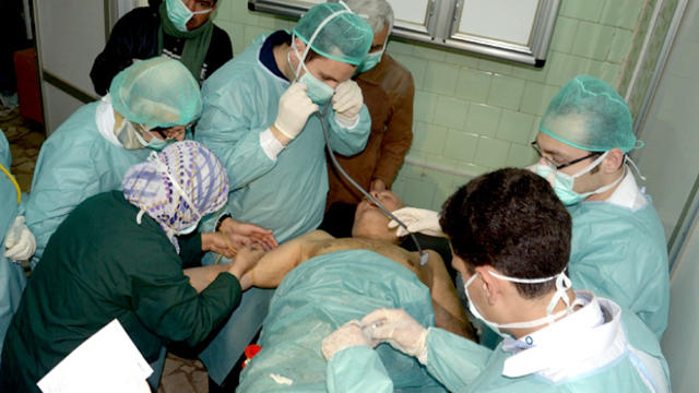 In this photo released by the Syrian official news agency SANA, a Syrian victim who suffered an alleged chemical attack at Khan al-Assal village according to SANA, receives treatment by doctors, at a hospital in Aleppo, Syria, Tuesday March 19, 2013. The  