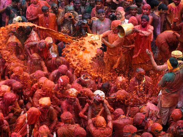 Villagers from Nandgaon throw colored water on the villagers from Barsana as they arrive at the Nandagram temple, famous for Lord Krishna and his brother Balram, during Lathmar Holi festival in Nandgaon, 75 miles from New Delhi, March 22, 2013. During Lat 