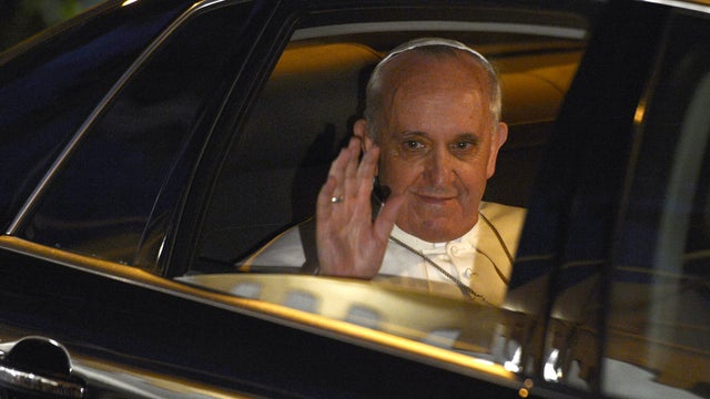 Pope Francis waves as he leaves the prison for minors 'Casal del Marmo' after a mass of the Lord's Supper on Holy Thursday on March 28, 2013 in Rome.  
