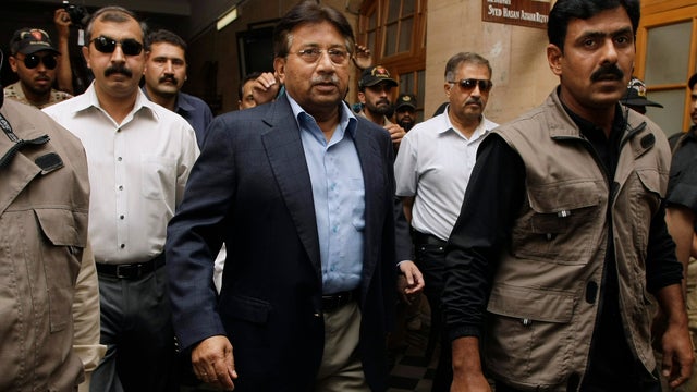 Former Pakistani President Pervez Musharraf, center, surrounded by guards, arriving in a court in Karachi, Pakistan in March 